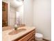Bathroom features a wood vanity with marbled sink top and neutral paint at 6719 Love Point Rd, Denver, NC 28037