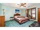 Bedroom with serene lake view, complemented by a classic ceiling fan at 6719 Love Point Rd, Denver, NC 28037