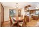Cozy dining room with hardwood floors, traditional furnishings, and a view into the adjacent kitchen at 6719 Love Point Rd, Denver, NC 28037