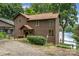 Charming lake house with wood siding, inviting front porch, and serene lake views at 6719 Love Point Rd, Denver, NC 28037