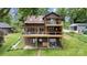 Brown exterior lake house with two wooden decks, surrounded by a lawn and mature trees at 6719 Love Point Rd, Denver, NC 28037