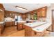 Traditional kitchen with wood cabinets, tiled countertops, and an eat-in bar overlooking the rest of the house at 6719 Love Point Rd, Denver, NC 28037