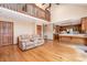 Open concept living space with hardwood floors, a vaulted ceiling, and a view of the kitchen and loft at 6719 Love Point Rd, Denver, NC 28037