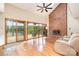 Bright living room with hardwood floors, vaulted ceilings, a brick fireplace and scenic lake views at 6719 Love Point Rd, Denver, NC 28037