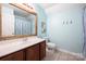 Bright bathroom features a wood-trimmed mirror and a single sink vanity at 7101 Weavers Run, Cramerton, NC 28032