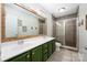 Bathroom featuring a double sink vanity and enclosed glass shower at 7101 Weavers Run, Cramerton, NC 28032