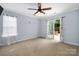 A carpeted bedroom featuring sliding glass doors to a private patio at 7101 Weavers Run, Cramerton, NC 28032