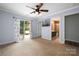 A carpeted bedroom featuring sliding glass doors to a private patio at 7101 Weavers Run, Cramerton, NC 28032