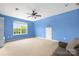 Bonus room featuring blue walls, carpet, and a large window at 7101 Weavers Run, Cramerton, NC 28032