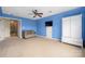 Spacious blue bonus room features a ceiling fan and comfortable seating at 7101 Weavers Run, Cramerton, NC 28032