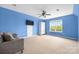 Blue bonus room featuring a couch, storage cabinet and large window at 7101 Weavers Run, Cramerton, NC 28032