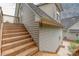 Exterior stairs lead to an upper-level deck, providing a picturesque view of the surrounding landscape at 7101 Weavers Run, Cramerton, NC 28032