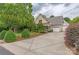Inviting home with a spacious driveway, well-maintained lawn, and attached garages at 7101 Weavers Run, Cramerton, NC 28032