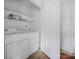 White laundry room with washer, dryer, and shelving at 7101 Weavers Run, Cramerton, NC 28032