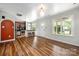 Open-concept layout with kitchen, breakfast bar, and living area with hardwood flooring at 7101 Weavers Run, Cramerton, NC 28032