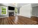 Cozy living room with a fireplace, wood floors, and bright natural light at 7101 Weavers Run, Cramerton, NC 28032