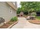 Outdoor patio features a brick fireplace, comfortable seating, and string lights for cozy outdoor entertaining at 7101 Weavers Run, Cramerton, NC 28032