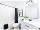 Bathroom featuring a shower and tub combo, black hardware, white cabinets, and a framed mirror at 810 W Raleigh Ave, Statesville, NC 28677