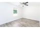 Bedroom featuring light gray flooring, white walls, a ceiling fan, and a window for natural light at 810 W Raleigh Ave, Statesville, NC 28677