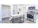 Modern kitchen showcasing stainless steel appliances, an island, and convenient access to the laundry room at 810 W Raleigh Ave, Statesville, NC 28677