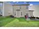 Back yard with a patio and furniture, grill, and a grassy lawn with a view of the house at 920 Old Forester Ln, Charlotte, NC 28214