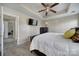 Bedroom with tray ceiling, ceiling fan, and television with a view of an open door to another room at 920 Old Forester Ln, Charlotte, NC 28214