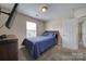 Comfortable bedroom features a large window, a full bed, and built-in media cabinet at 920 Old Forester Ln, Charlotte, NC 28214