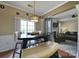 Open-concept eat-in kitchen area flows into a cozy living space with decorative light fixture at 920 Old Forester Ln, Charlotte, NC 28214