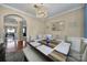 Elegant dining room featuring a chandelier, decorative mirror, and a stylish table with bench seating at 920 Old Forester Ln, Charlotte, NC 28214