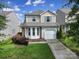 Charming two-story home with a well-manicured lawn, inviting entrance, and attached one car garage at 920 Old Forester Ln, Charlotte, NC 28214