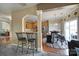 Open kitchen featuring granite countertops, wood cabinets, and bar seating area looking into eat-in dining space at 920 Old Forester Ln, Charlotte, NC 28214