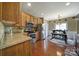 Well-equipped kitchen with wood cabinets, stainless steel appliances, and adjacent eat-in area at 920 Old Forester Ln, Charlotte, NC 28214