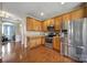 Well-equipped kitchen with wood cabinets, stainless steel appliances, and adjacent eat-in area at 920 Old Forester Ln, Charlotte, NC 28214