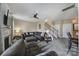 Open-concept living area with carpeted floor, fireplace, ceiling fan, and staircase leading to the second floor at 920 Old Forester Ln, Charlotte, NC 28214
