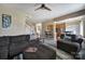 Cozy living room with carpet, fireplace, dark couches, and seamless access to the kitchen and dining area at 920 Old Forester Ln, Charlotte, NC 28214