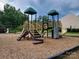A vibrant community playground featuring slides, climbing structures, and a wood chip safety surface at 920 Old Forester Ln, Charlotte, NC 28214