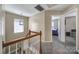 Carpeted staircase leads to a bright upper landing, offering a glimpse into a cozy bedroom at 920 Old Forester Ln, Charlotte, NC 28214