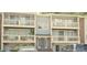 Condo exterior with balconies, neutral siding, and a blue front door at 9501-A Shannon Green Dr, Charlotte, NC 28213