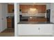 Kitchen with wood cabinets, black appliances, and stone tile backsplash at 9501-A Shannon Green Dr, Charlotte, NC 28213