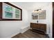 Modern bathroom with wood vanity, ample lighting, and sleek fixtures, offering a contemporary design at 985 Needmore Rd, Woodleaf, NC 27054