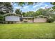 Well maintained mid-century modern home showcasing stylish architectural details on a lush lot at 985 Needmore Rd, Woodleaf, NC 27054