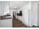 Well-lit kitchen featuring white cabinets, laminate flooring and ample counter space at 985 Needmore Rd, Woodleaf, NC 27054