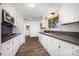 Bright kitchen with white cabinets, modern appliances, and laminate floors at 985 Needmore Rd, Woodleaf, NC 27054