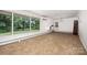 Bright and airy living room featuring large windows overlooking the lush backyard at 985 Needmore Rd, Woodleaf, NC 27054
