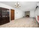 Spacious living room with a brick fireplace, large windows, and ample natural light at 985 Needmore Rd, Woodleaf, NC 27054