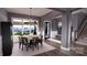 A modern dining room with large windows offers scenic views and a cozy dining experience at 0 Mineral Ln, Lincolnton, NC 28092