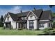 Attractive exterior of home with black trim, brick accents, manicured lawn, and eye-catching roof design at 0 Mineral Ln, Lincolnton, NC 28092