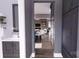 Hallway view to a modern open-concept home with a bathroom on the left, and kitchen/living area straight ahead at 0 Mineral Ln, Lincolnton, NC 28092