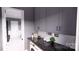 A functional laundry room features marble countertops, gray cabinetry, and modern appliances at 0 Mineral Ln, Lincolnton, NC 28092