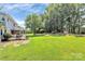 Large backyard featuring a screened porch, mature trees and open space at 1011 Bydeford Ct, Matthews, NC 28105